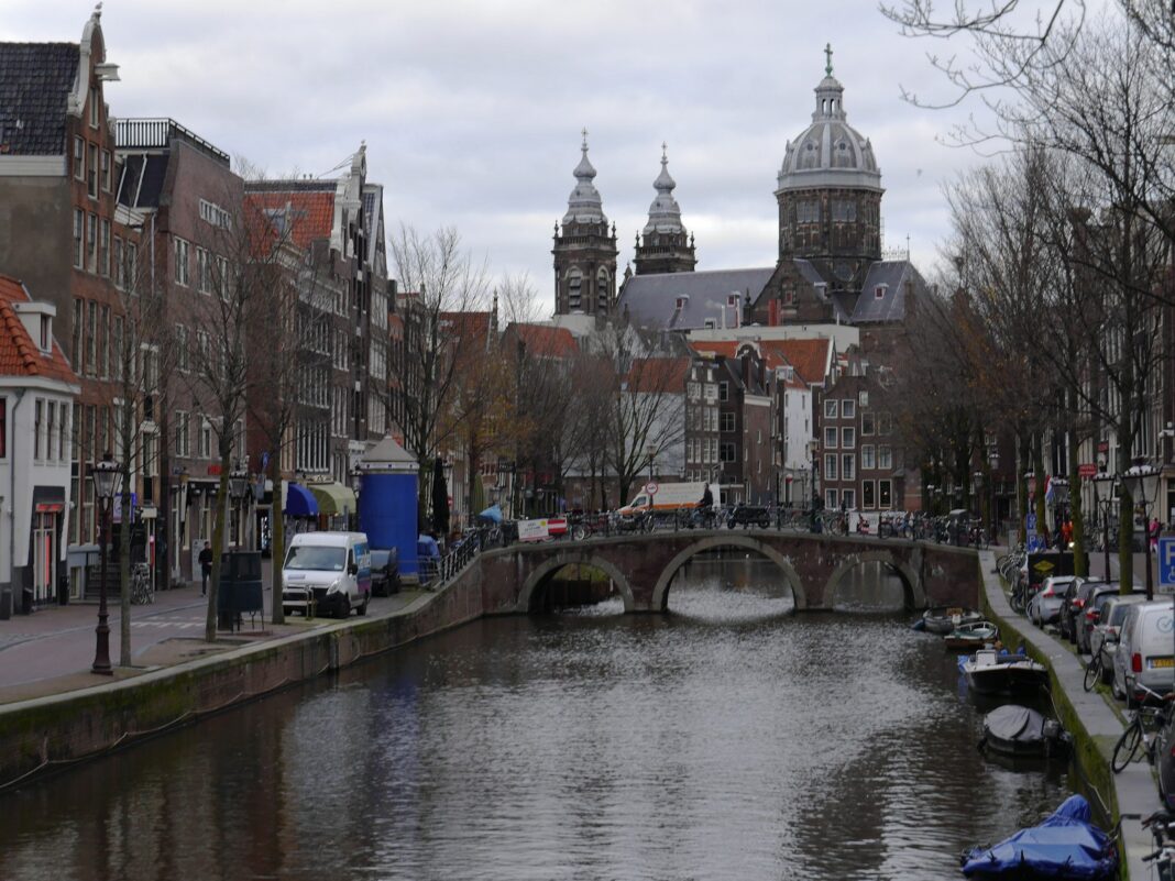 a river running through a city next to tall buildings