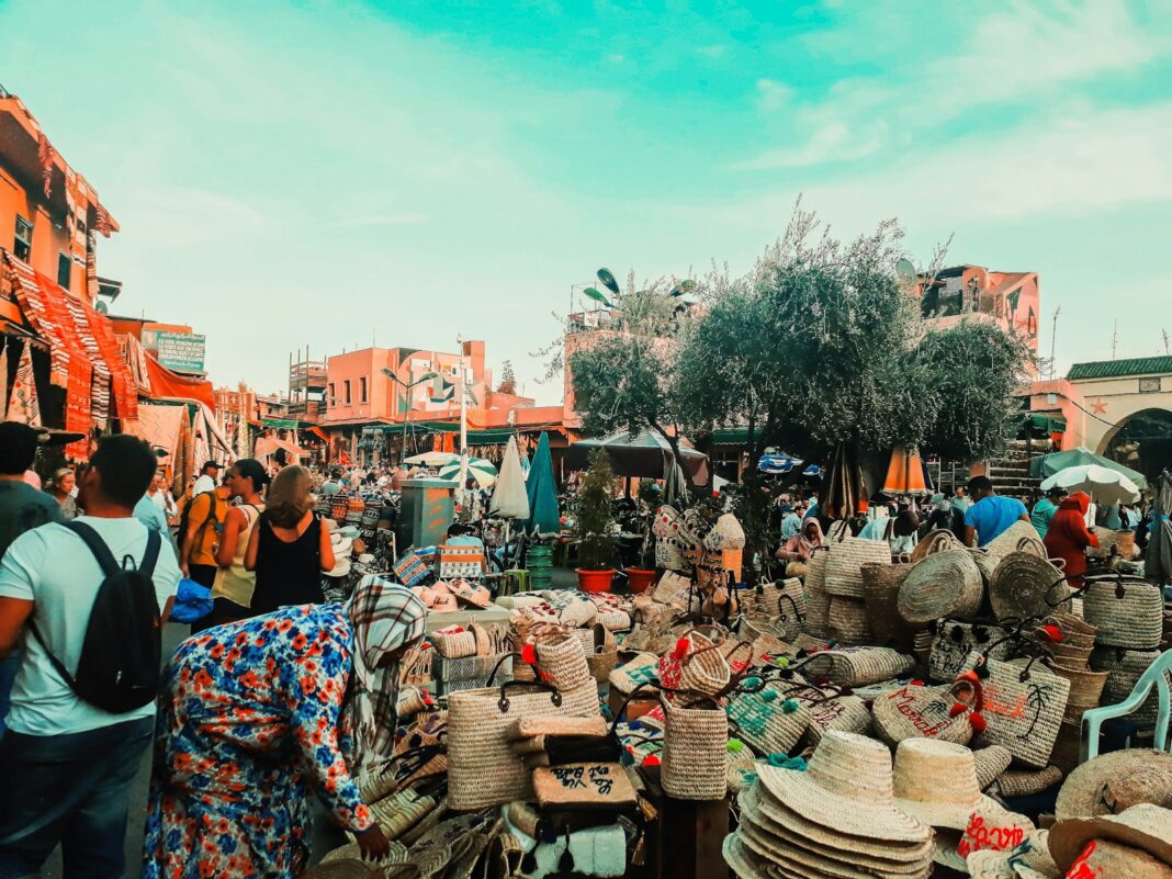 people sitting on brown wooden chairs during daytime